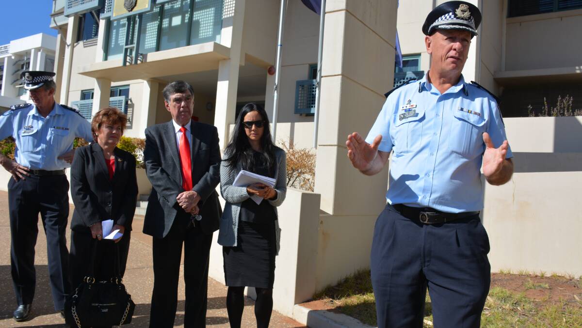 Debrief: Police Minister Jo-Ann Miller (second from left) waits as Acting Assistant Commissioner Paul Taylor updates media representatives on the investigation. 