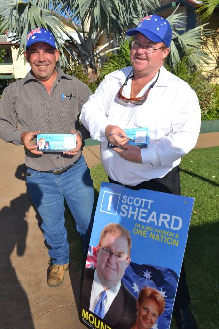Patriotic: One Nation candidate Scott Sheard offers how-to-vote cards at Central State School, Mount Isa. 