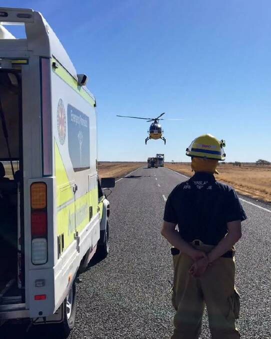 Response: A Queensland Fire and Rescue  Emergency Services road crew member at the rollover site. Photo: RACQ North Queensland Rescue Helicopter Service.