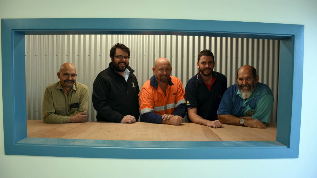 ON EXHIBIT: Mount Isa Fish Stocking Group hatchery co-ordinator George Fortune, George Fisher mine manager Stu Reid, Clancy Corporation managing director Dave Clancy, CNW Mount Isa manager Dave Diehm and Mount Isa Fish Stocking Group president Steve Farnsworth pretend they are in a fish viewing tank to be built in the hatchery. 