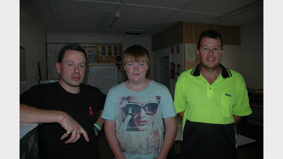 Riley Davenport, 13, centre, was a “runner” between a Laura shop and the neighbouring CFS station with food for the fire-fighters until 
about 4am on Sunday. Riley also helped fill water trucks. He is with Laura CFS volunteers Brett Stewart, left, and Daniel Schultz. Photo: Greg Mayfield.