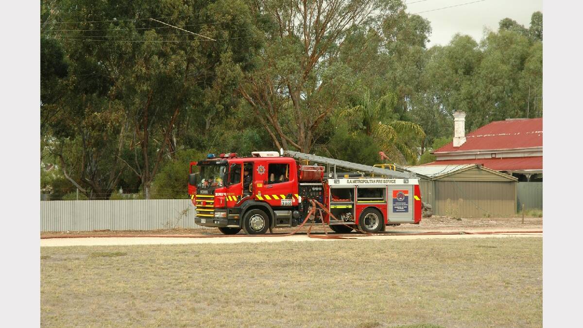 A Metropolitan Fire Service trucks remains on standby on the edge of Wirrabara as 
flames head toward the town. Photo:Greg Mayfield.