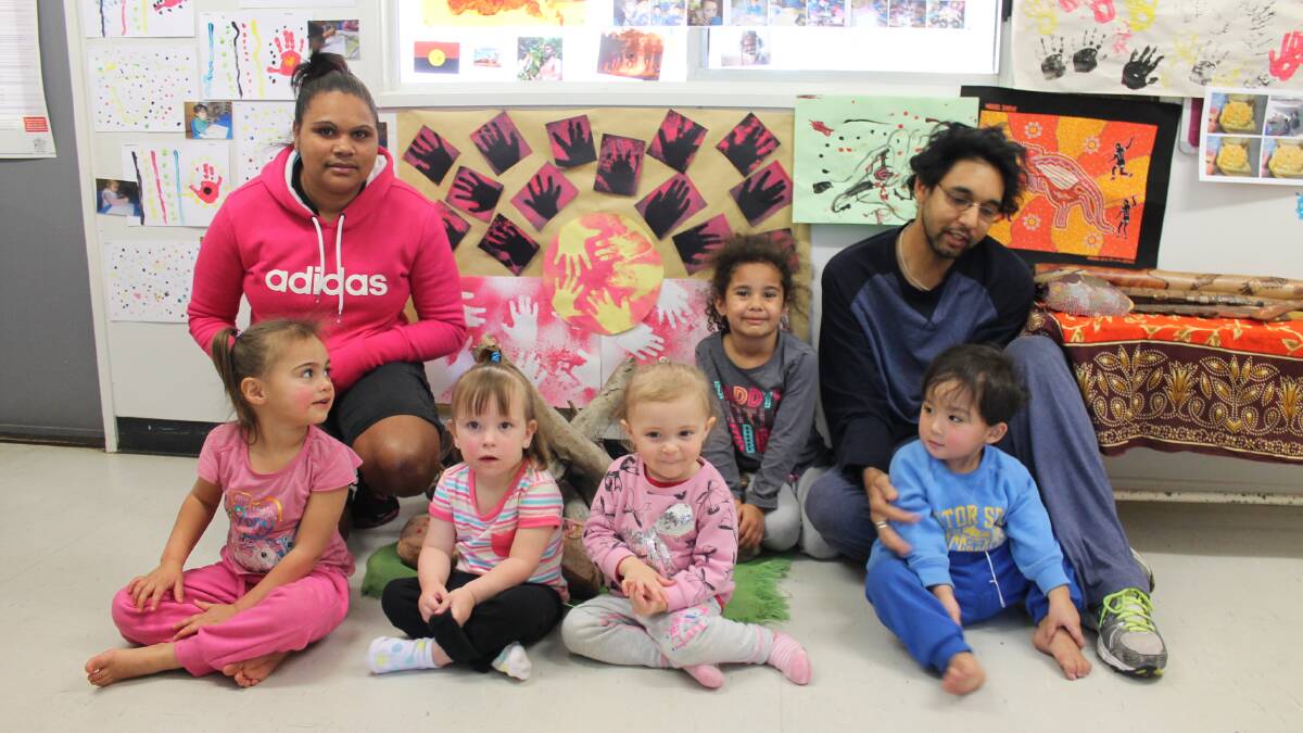  St Pauls Lutheran Church Child Care educators Kahna Rankine and Casey Ah Wing with Ruby Steed, 3, Ella Hay, 2, Ayla Coles, 2, Jazlyn, 5, and Lee Ibardolaza, 2, in front of the kindy’s NAIDOC Week display.