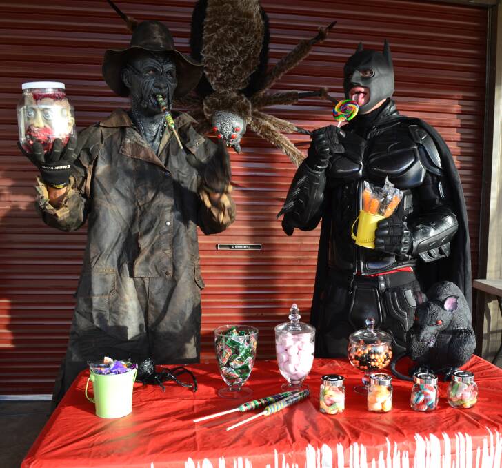 FRIGHTENING SIGHT: Jeepers Creepers (Pitt Ross) and Batman (Luke “Duke” Bellamy) get distracted by lollies when setting up for the Halloween Youth Community Event. 