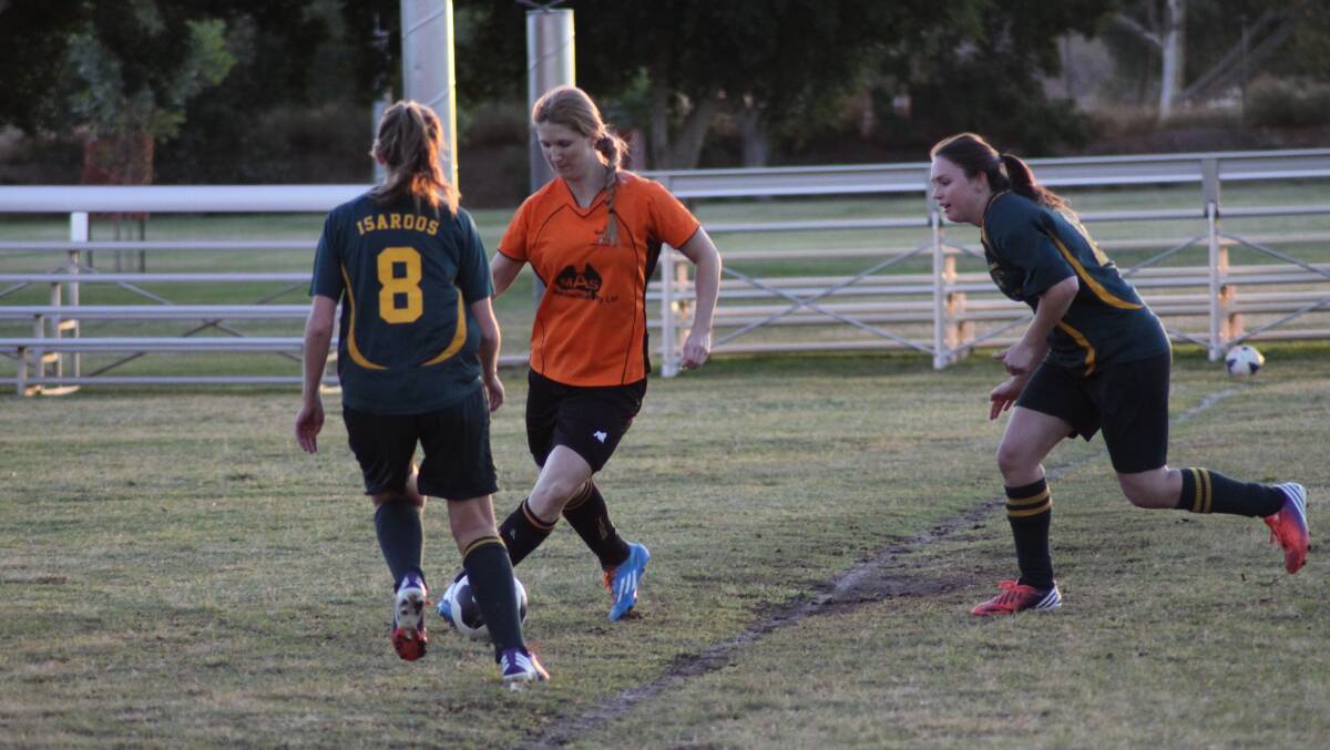 TABLE-TOPPING TIGERS: Tigers star Sharon Voss tries to get a pass away despite pressure from two Isaroos defenders.