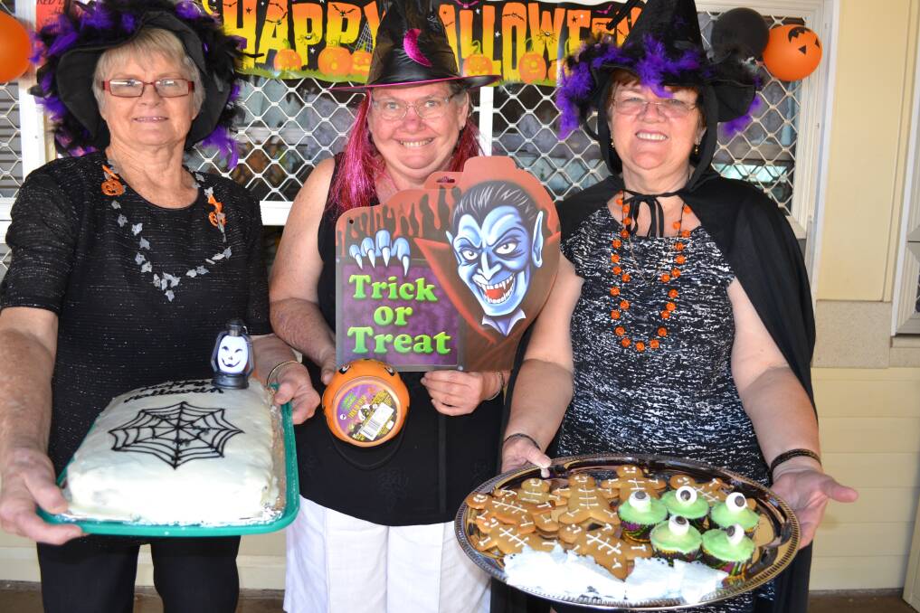 HAPPY HALLOWEEN: Townview State School tuck shop workers Margi Sporer, Margaret Hill and Ronda Llewellyn dressed up as witches and served Halloween-themed food  yesterday.