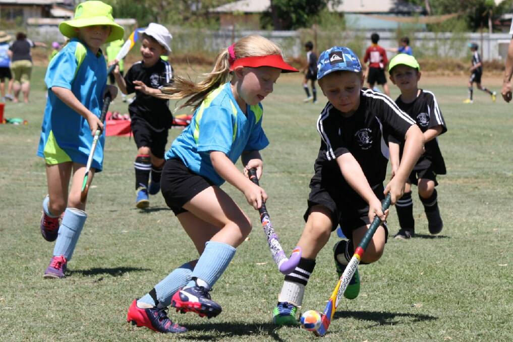 TIGHT BATTLE: TBirds U11 Anthony Kleinman tries to rake the ball from Hornets U11 Erin Simpson.