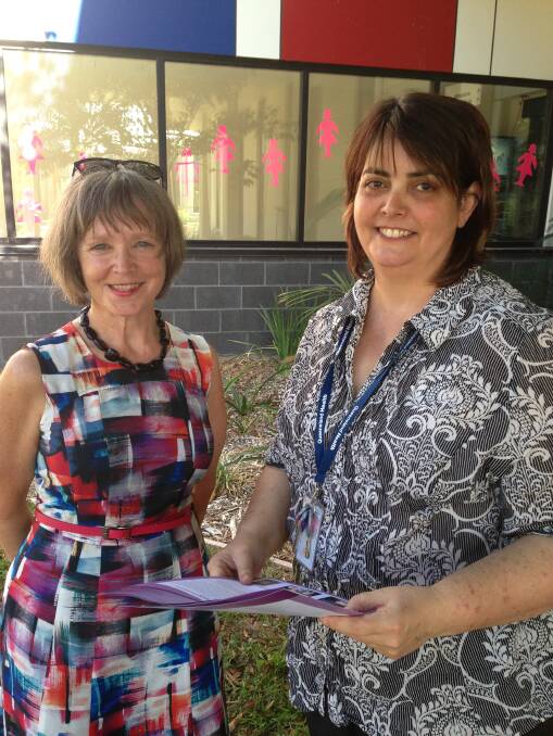 Geraldine Vaughan shares the AMOSS newsletter with maternity nurse unit manager Rebecca Sibbick.