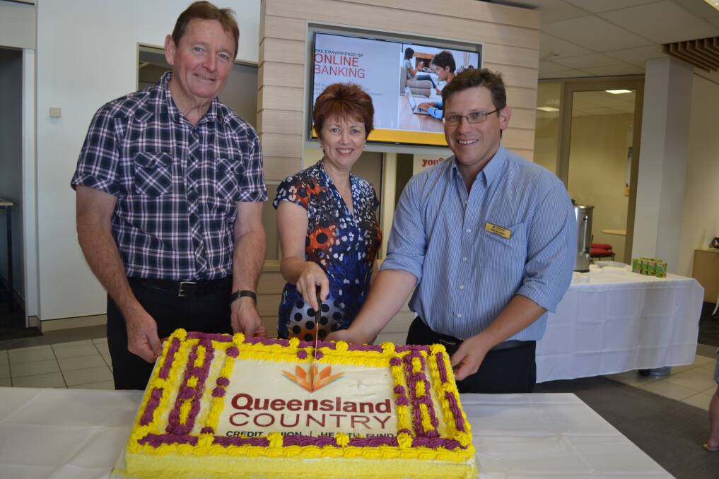 CAKE CUTTERS: Queensland Country Credit Union chairman Bruno Cullen, chief executive Aileen Cull and Mount Isa branch manager Dan Horrobin cut a cake to celebrate the refurbishment of the Mount Isa branch.
