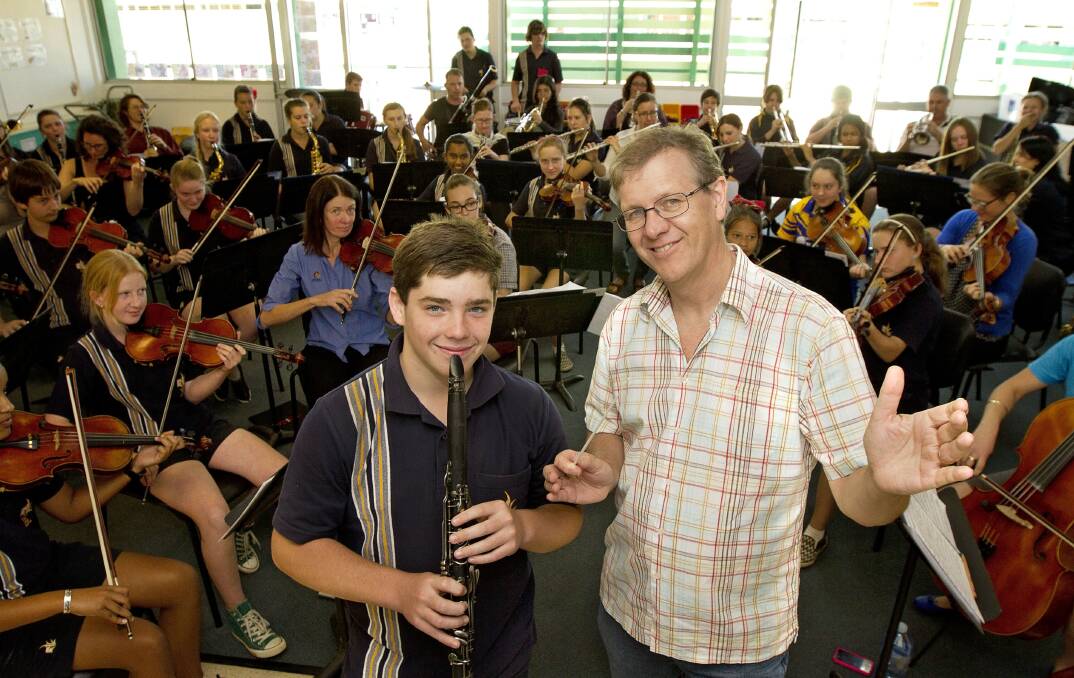 Student Jason Knight, 15, with conductor Guy Noble, as students from across the North West enjoy a workshop with the Queensland Symphony Orchestra at Healy State School. 
