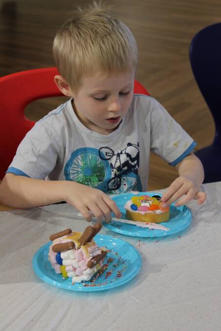 Connor Williams, 4, hard at work finishing off his cake.