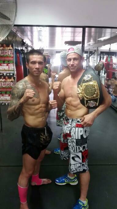 CONFIDENT: Mount Isa muay thai fighter Michael New with his coach Bruce ‘‘Preacher’’ Macfie (wearing his recently won world title belt).