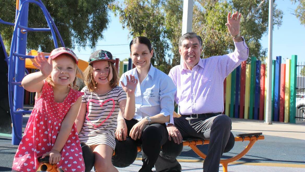 SMILE, YOU’RE ON CAMERA: Olive Hilbert, 4, Ruby Hilbert, 6, Michelle Connolly, of Mount Isa Mines, and Mayor Tony McGrady.