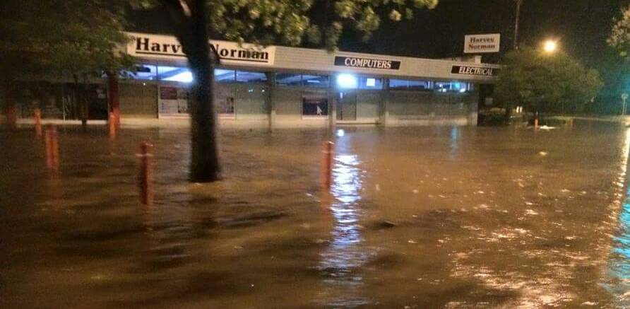 MILES STREET: The water level at its high point in front of Harvey Norman early yesterday morning.