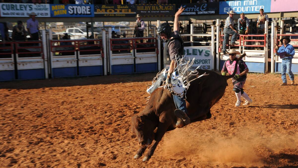 IN FLIGHT: Cody Tully competes in the steer ride at the Boulia Rodeo. - Picture: Ann Britton Photography/www.annbrittonphotography.com.au/