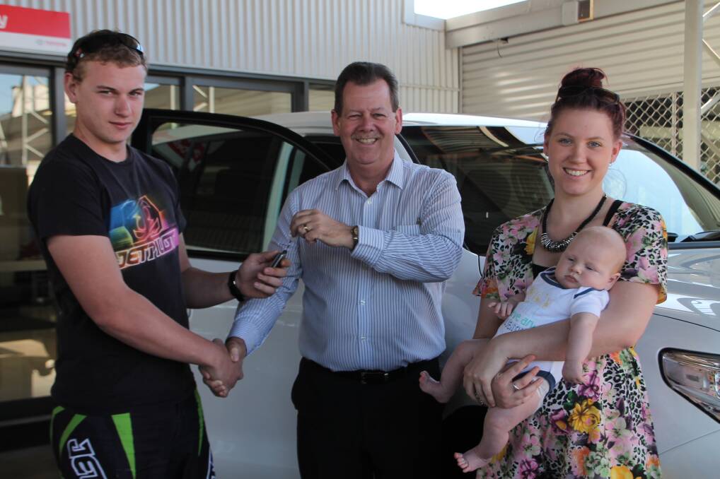 WINNERS: Bell and Moir Toyota  principal Lee Pulman was happy to hand the keys to the 2015 Mount Isa Rotary Rodeo Art Union winner Corey Coghlan and his family, Kayla Bartram and baby Hunter Coghlan. 
