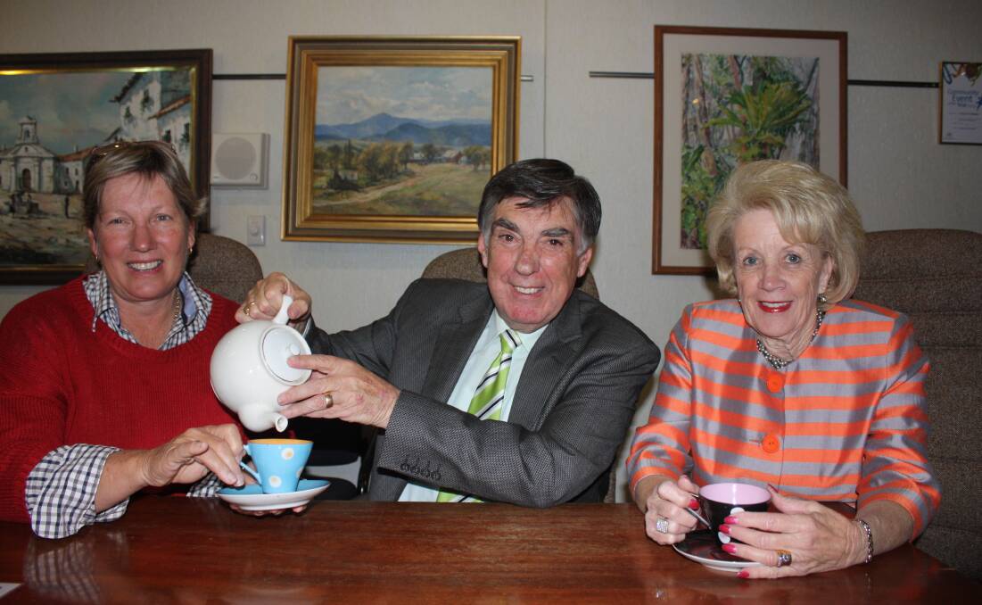 Mayor Tony McGrady practises his tea-pouring skills with Councillor Anne Seymour and Sandra McGrady before the Seniors Morning Tea.

