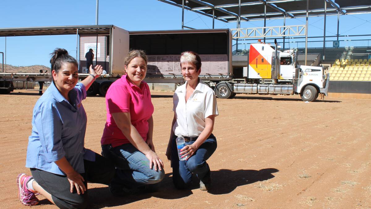 HARD YAKKA: Louise Brogden, Donna Cole and Aurizon's Donna McCormack worked through yesterday's heat to get the stage and bar ready for Saturday's  Isa Fest.