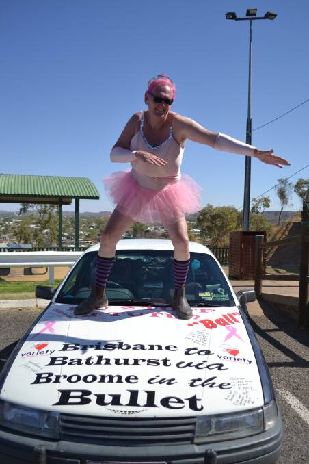 PRETTY IN PINK: Brendan Edgerton bonnet surfs on his world-famous Bullet while visiting the Mount Isa lookout.