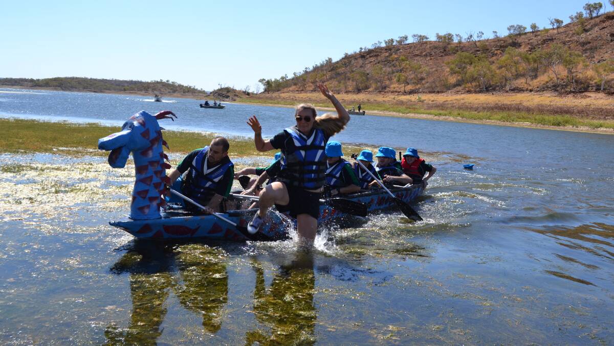 ABANDON DRAGON BOAT: Mount Isa Mines’ Lara Lavers in a hurry to get out of the boat in the Lake Moondarra Fishing Classic Dragon Boat Regatta.

