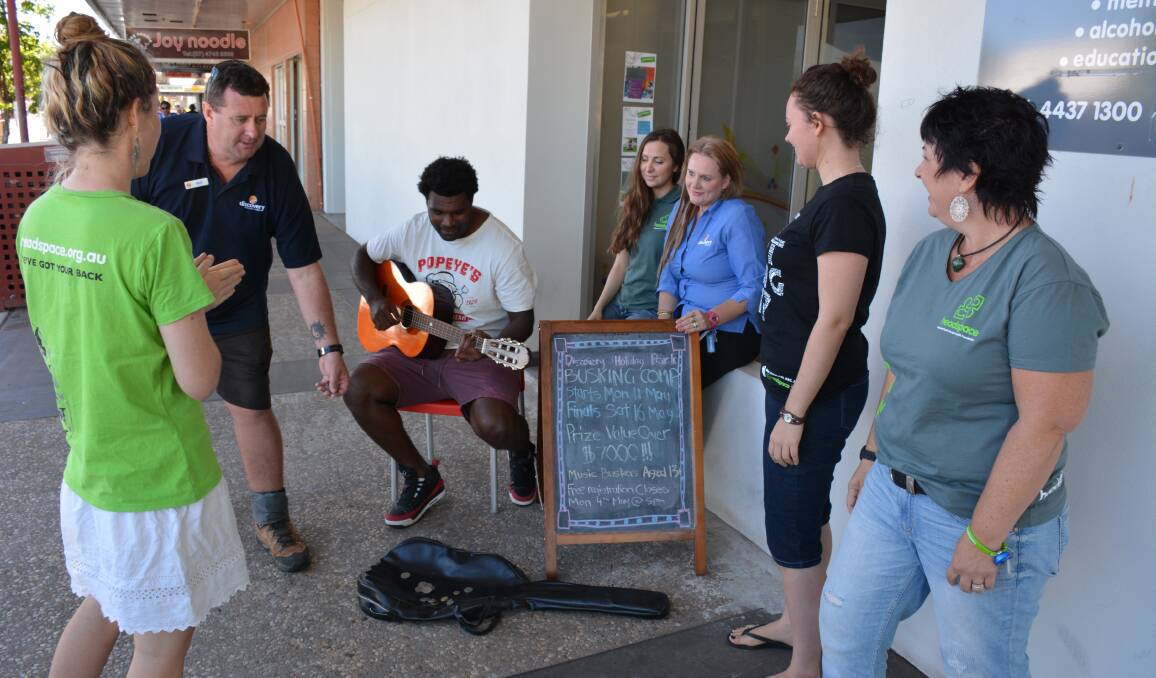 WARM-UP: Jacob Takurit gathers a crowd while practising for the busking competition in West Street. The busking competition will be held in the lead-up to Isa Fest in May.