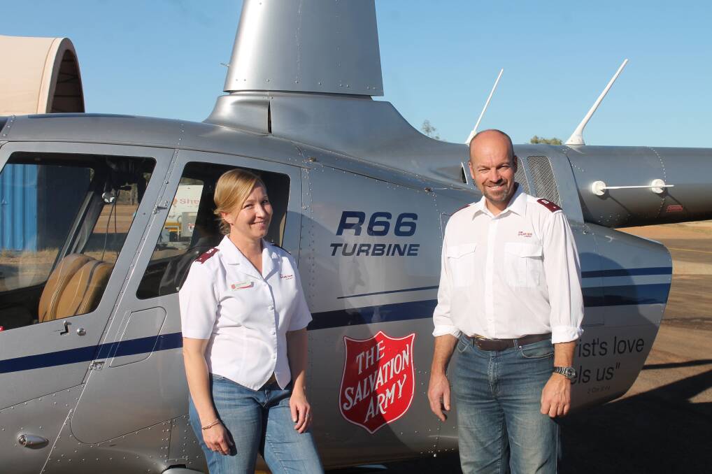 SALVATION SOARS: The Flying padres, Nat and Simon Steele, with their Robinson 66 Turbine helicopter at Mount Isa Airport. 