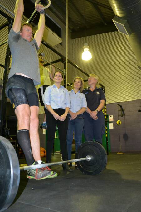FITNESS: Gym enthusiasts (from left) David Black and Wade Williams use the new facilities as Glencore Mount Isa Mines representatives Michelle Connelly, Jemma Schweikert and PCYC branch manager Gina Scott watch on.