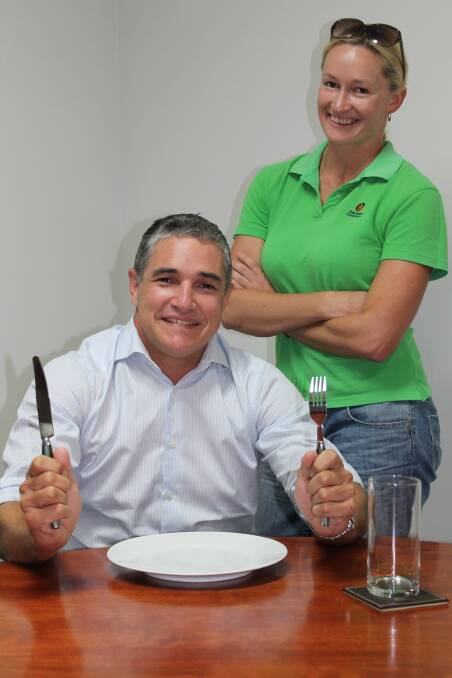 GOOD CAUSE: Lisa Ward makes sure that Rob Katter’s table manners are up to scratch before he is auctioned off for charity. 