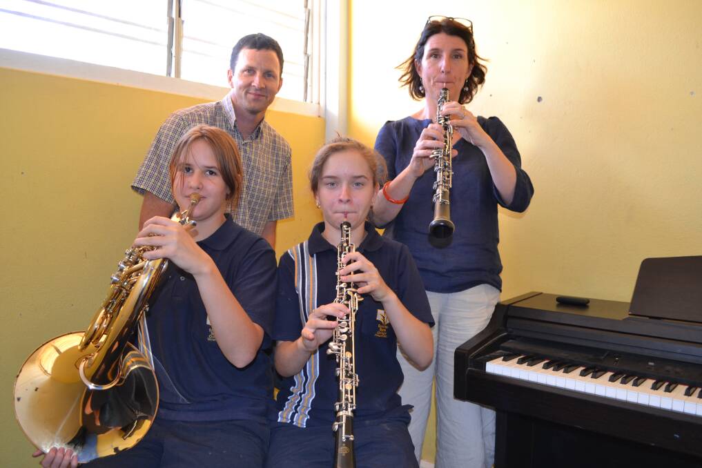 MUSICAL INSTRUCTION: Spinifex State College students Louise Eussen and Helena Fricke (front) practise for the Mount Isa Gala Concert with Queensland Symphony Orchestra members Malcolm Stewart and Sarah Meagher. 