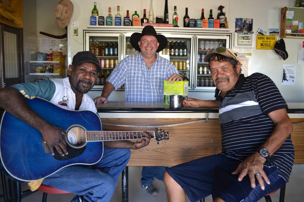 SERVICE WITH A SMILE: Ross Clark-Dwyer (centre) with regular patrons Drew Eric, who often entertains at the Dajarra Hotel, and Michael Scanlon.