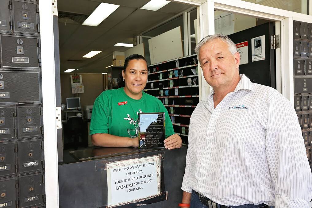 COURTESY COUNTS: Australia Post Mount Isa delivery centre customer service officer Tamara Raymond receives her award from Deputy Mayor Brett Peterson.
