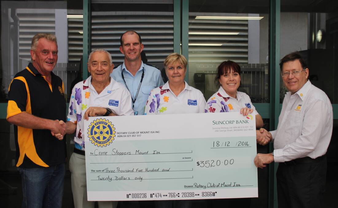 HANDOVER: Crime Stoppers committee member Les Bunn accepts the cheque from  Mount Isa Rotary Club president Paul Johnson (far right).  Also pictured (from left) are Rotary member Peter Baldwin,  Acting senior Sergeant Brad Inskip, treasurer Vicki Miller and member Kristy Moore.