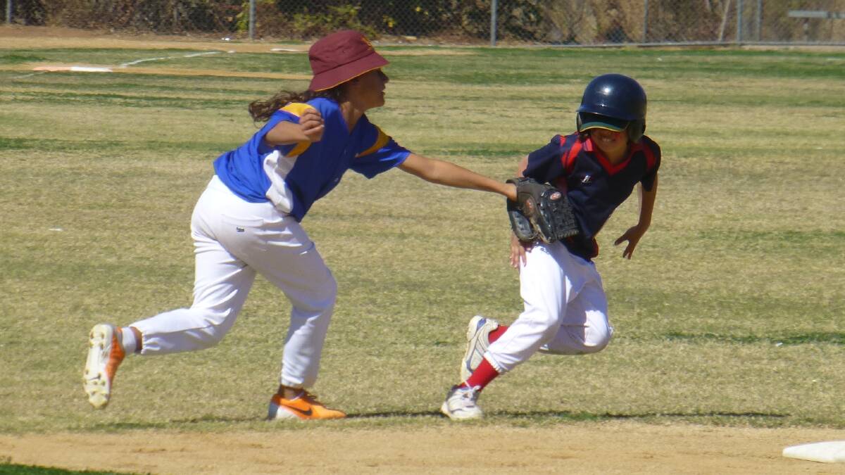 YOU’RE OUT: Under-12s Wanderers’ shortstop Aaliyah Harrison makes a successful tag out against Rebels runner Darcy Webber.