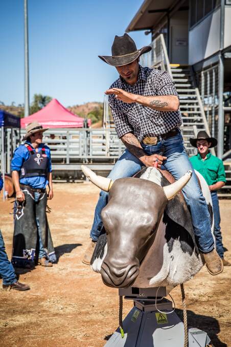 RIDE ’EM: Pietro Perri gets some practice in on the mechanical bull.
