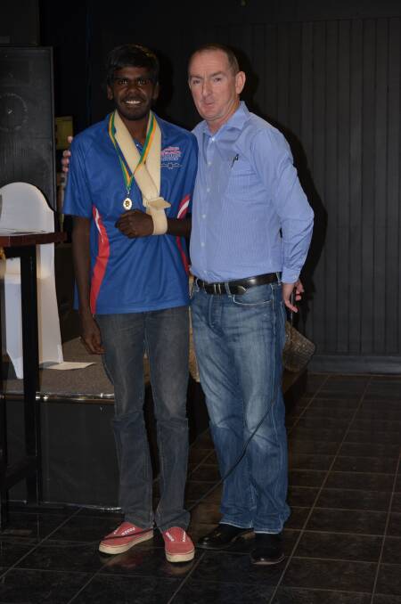 Young Guns midfielder Garrick Ray receives his Cargill Medal from Mount Isa AFL president Paul White. Picture: Tom Adam