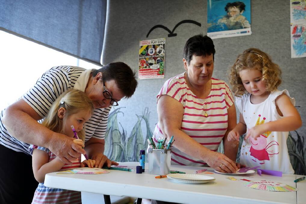 Craft time at the library sees Poppy Musgrave, of Holbrook, helping her granddaughter Logan, 5, and Lavington’s Judy Arendarcikas keeping busy with her granddaughter Grace, 3. 
