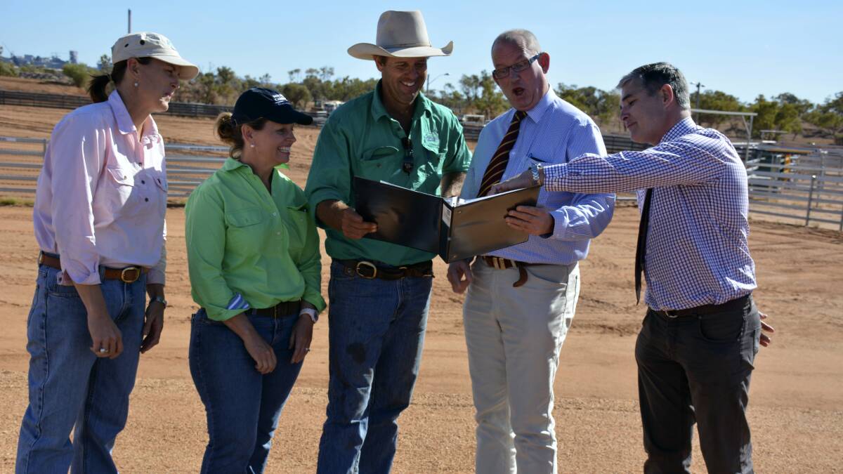 GOBSMACKED: Suzy Logan, Hannah and Peter Hacon and Mount Isa Member Rob Katter show Queensland Minister for Agriculture and Sport Bill Byrne photographs of what the campdraft grounds used to look like. Mr Byrne looks impressed.
