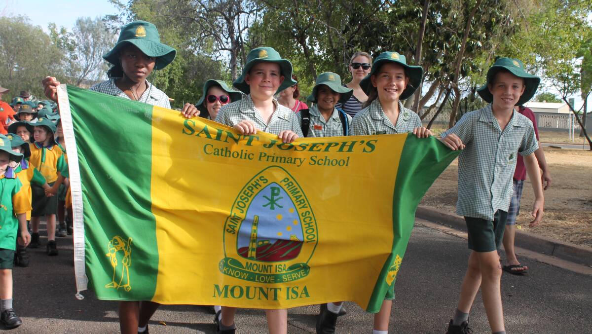 ST JOEYS: Tracy Mutimbe, 13, Justin Crick, 11, Ashleigh Stattmann, 12, and Darcy Ryder, 11, hold the banner for St Josephs in the Anzac Day Parade.