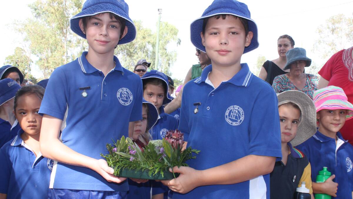 HAPPY VALLEY: Cody Burnett, 12, and Will Hamilton, 12, get ready to lay the wreath for Happy Valley State School.