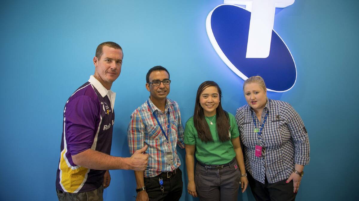 The Telstra Mount Isa team donating $3000 to Relay for Life chairman Ben MacRae.