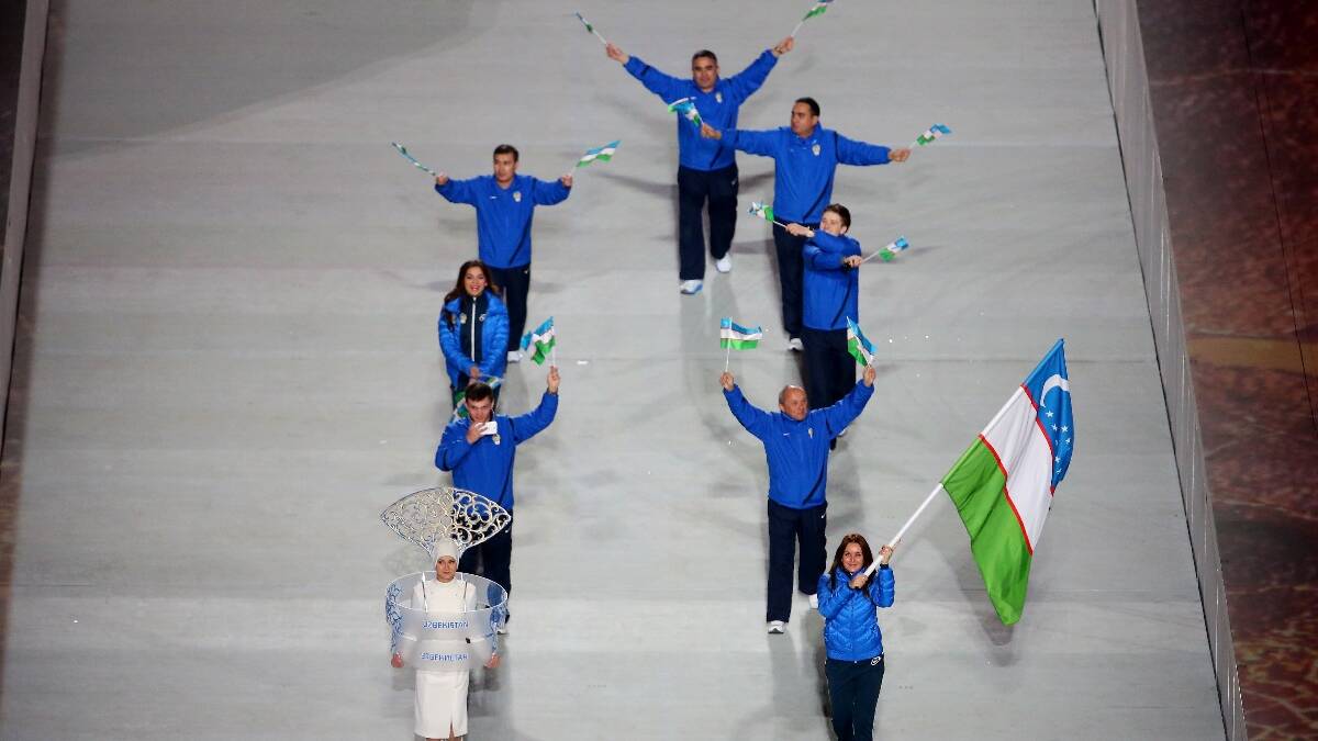 Kseniya Grigoreva of the Uzbekistan Olympic team carries her country's flag during the Opening Ceremony of the Sochi 2014 Winter Olympics. Picture: Getty