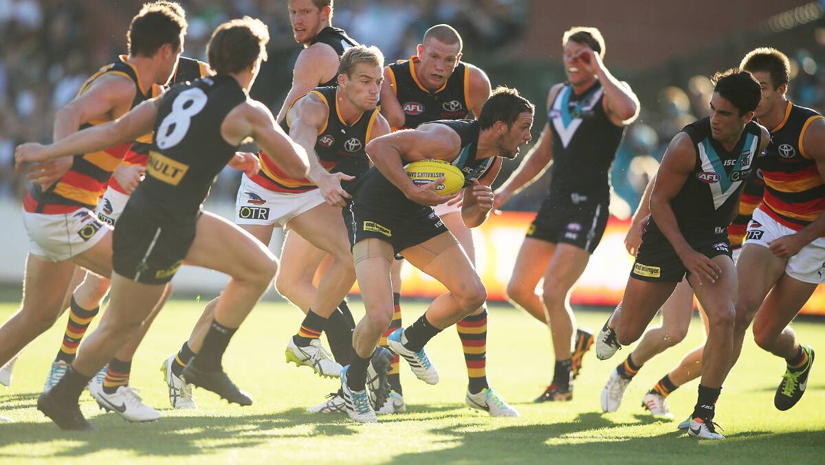 Travis Boak of the Power pushes though the group during the round two AFL match between the Port Adelaide Power and the Adelaide Crows at Adelaide Oval. Photos: Getty