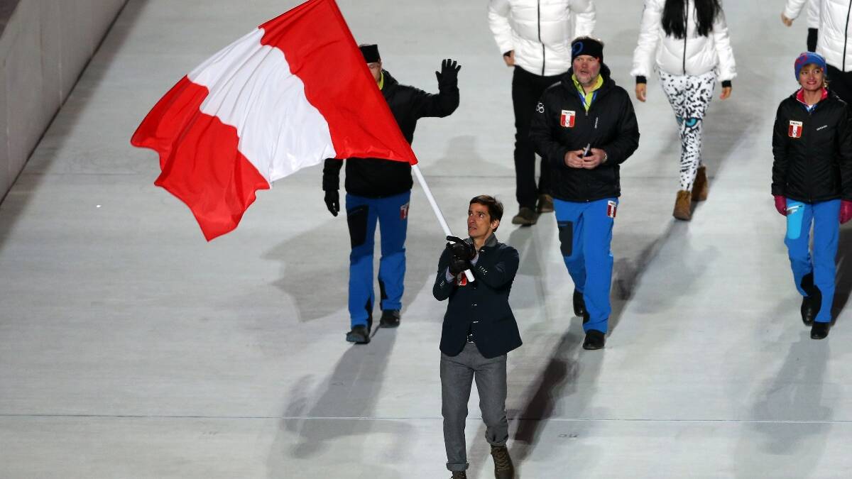 Cross country skier Roberto Carcelen of the Peru Olympic team carries his country's flag during the Opening Ceremony of the Sochi 2014 Winter Olympics. Picture: Getty