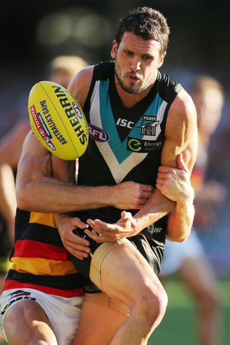 Travis Boak of the Power is tackled with the ball during the round two AFL match between the Port Adelaide Power and the Adelaide Crows. Photos: Getty