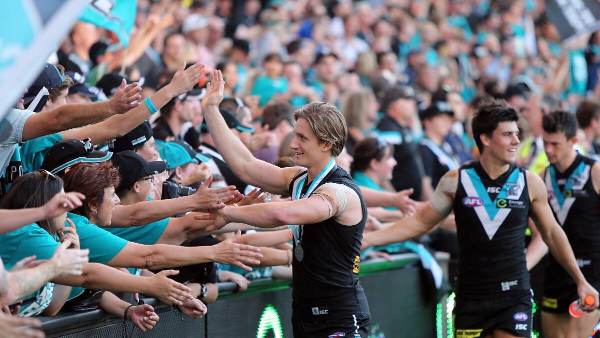 Hamish Hartlett of the Power celebrates with specators after winning round two AFL match between the Port Adelaide Power and the Adelaide Crows at Adelaide Oval on March 29. Photos: Getty