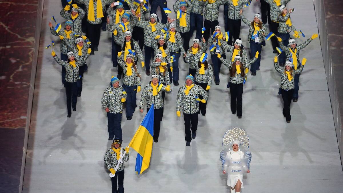 Valentina Shevchenko of the Ukraine Olympic team carries her country's flag during the Opening Ceremony of the Sochi 2014 Winter Olympics. Picture: Getty