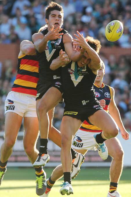 Players from both sides attempt a mark during the round two AFL match between the Port Adelaide Power and the Adelaide Crows. Photos: Getty