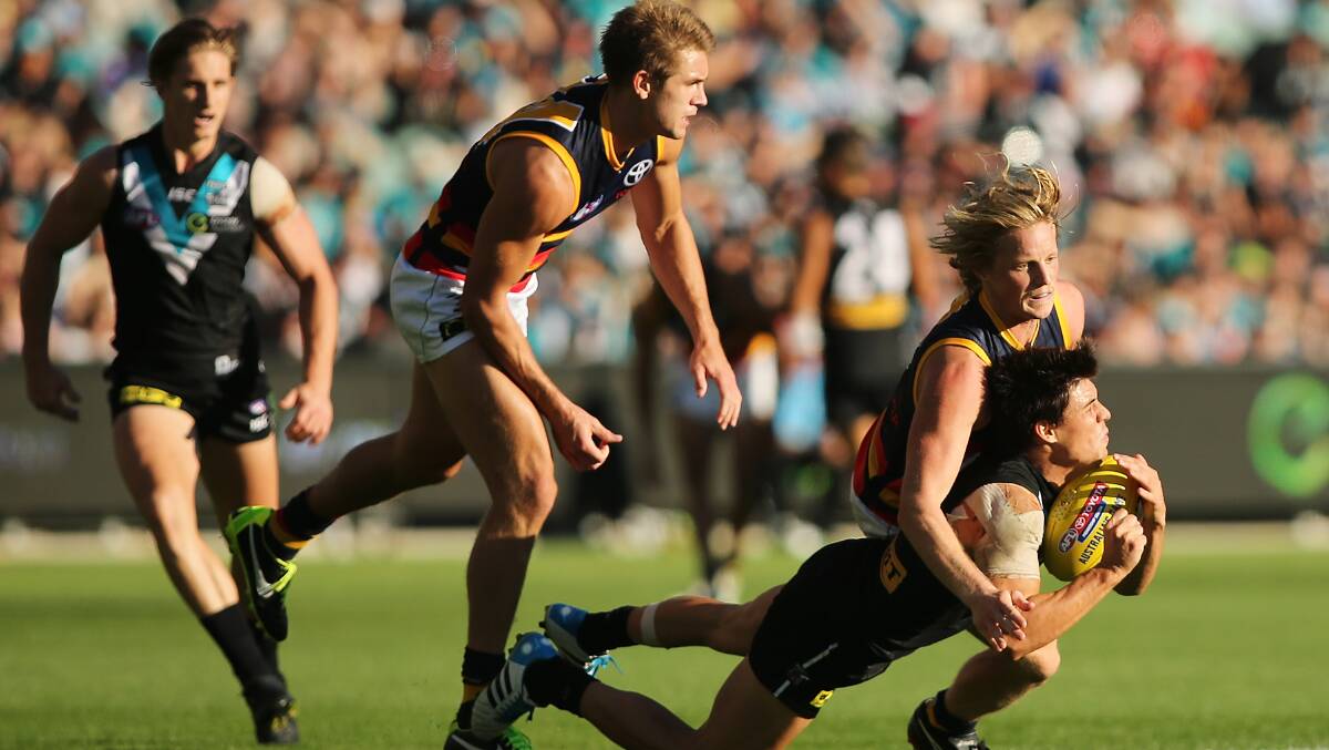 Rory Sloane of the Crows tackles Angus Monfries of the Power during the round two AFL match between the Port Adelaide Power and the Adelaide Crows. Photos: Getty