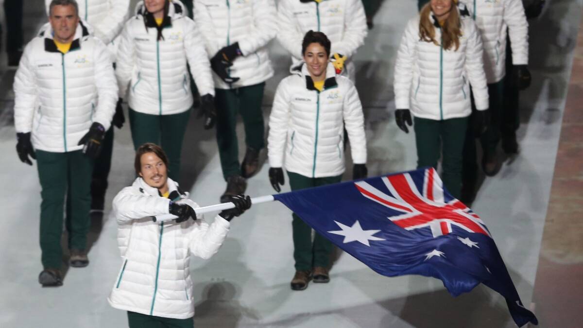 Snowboarder Alex Pullin of the Australia Olympic team carries his country's flag during the Opening Ceremony of the Sochi 2014 Winter Olympics. Picture: Getty