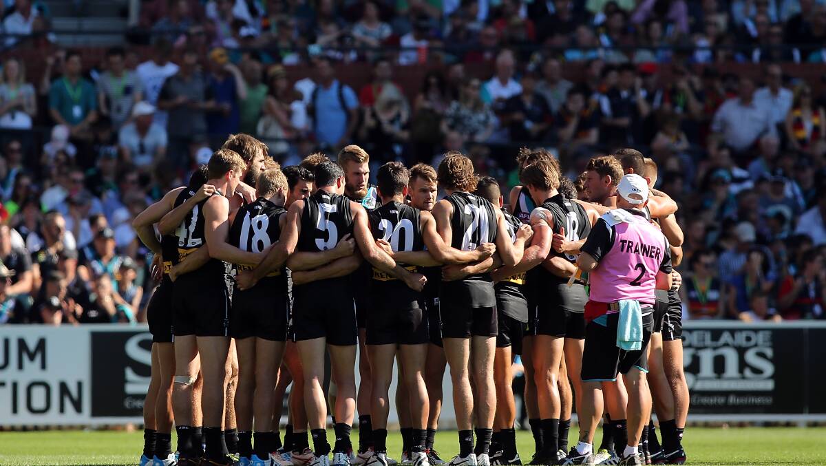 Power players form a huddle before the round two AFL match between the Port Adelaide Power and the Adelaide Crows at Adelaide Oval. Photos: Getty